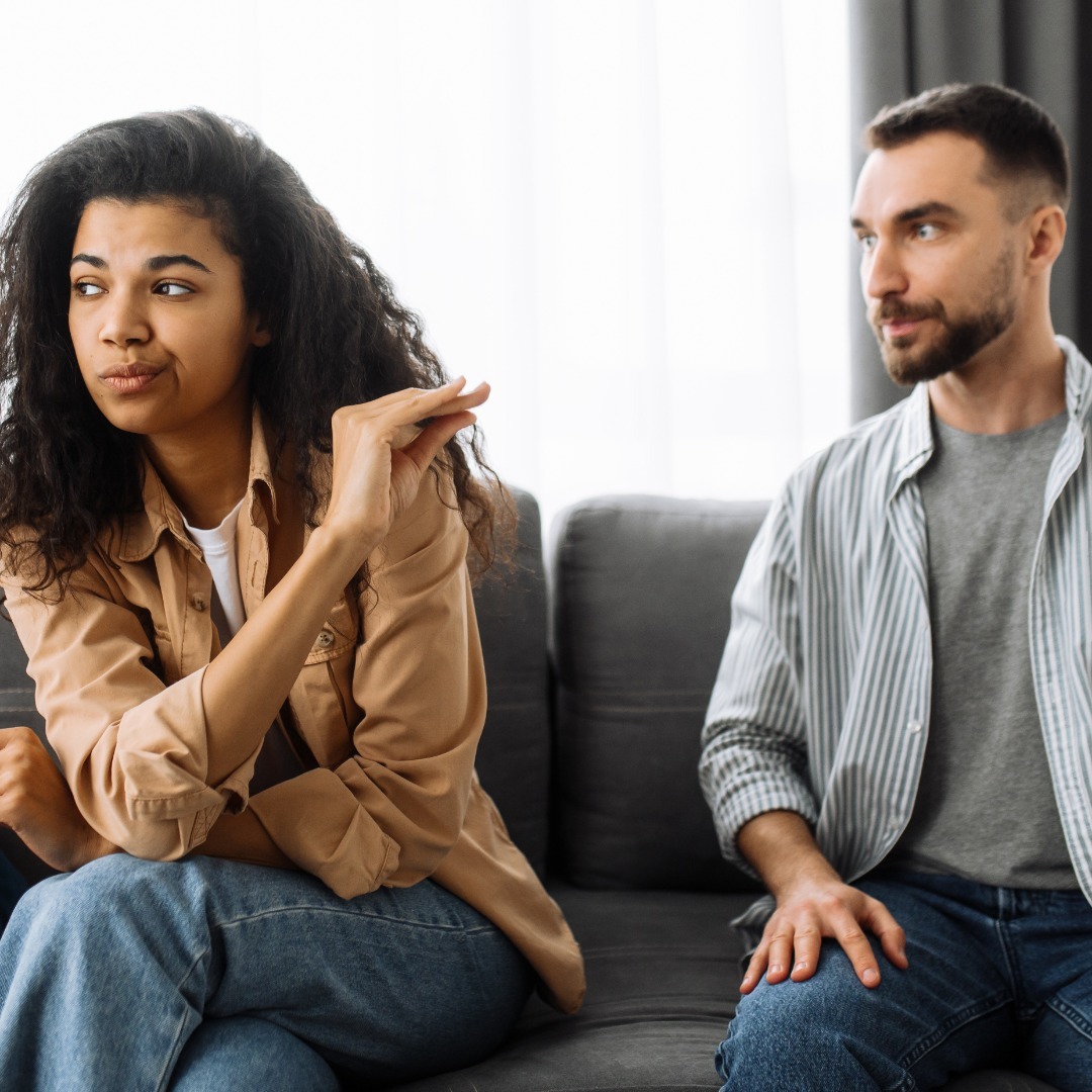 Woman makes talking hand motion toward partner as she looks away. Partner looks annoyed. Discuss critical matters like relationship and marriage finances with your partner.