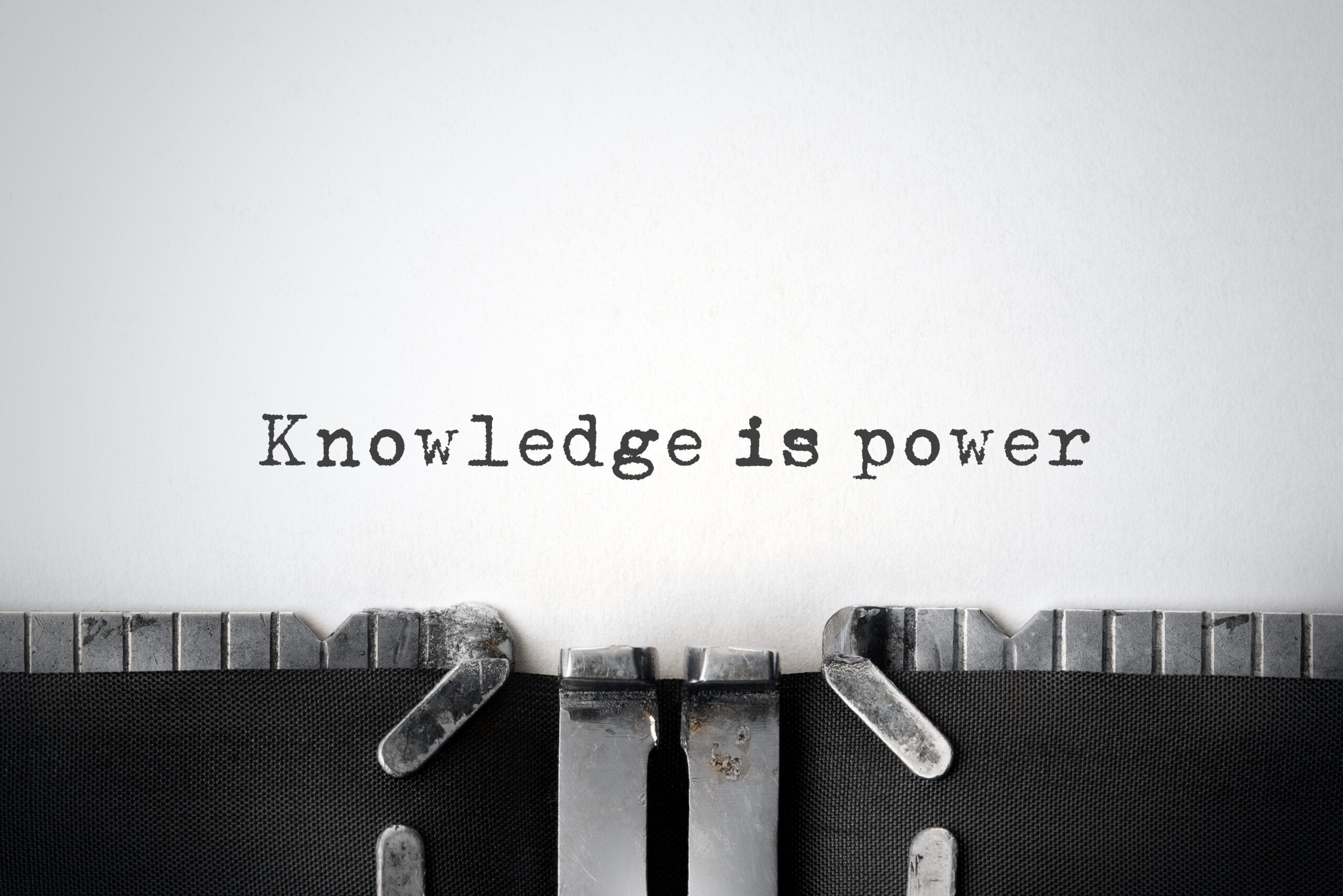 "Knowledge is power" is written on a piece of paper in a typewriter.
