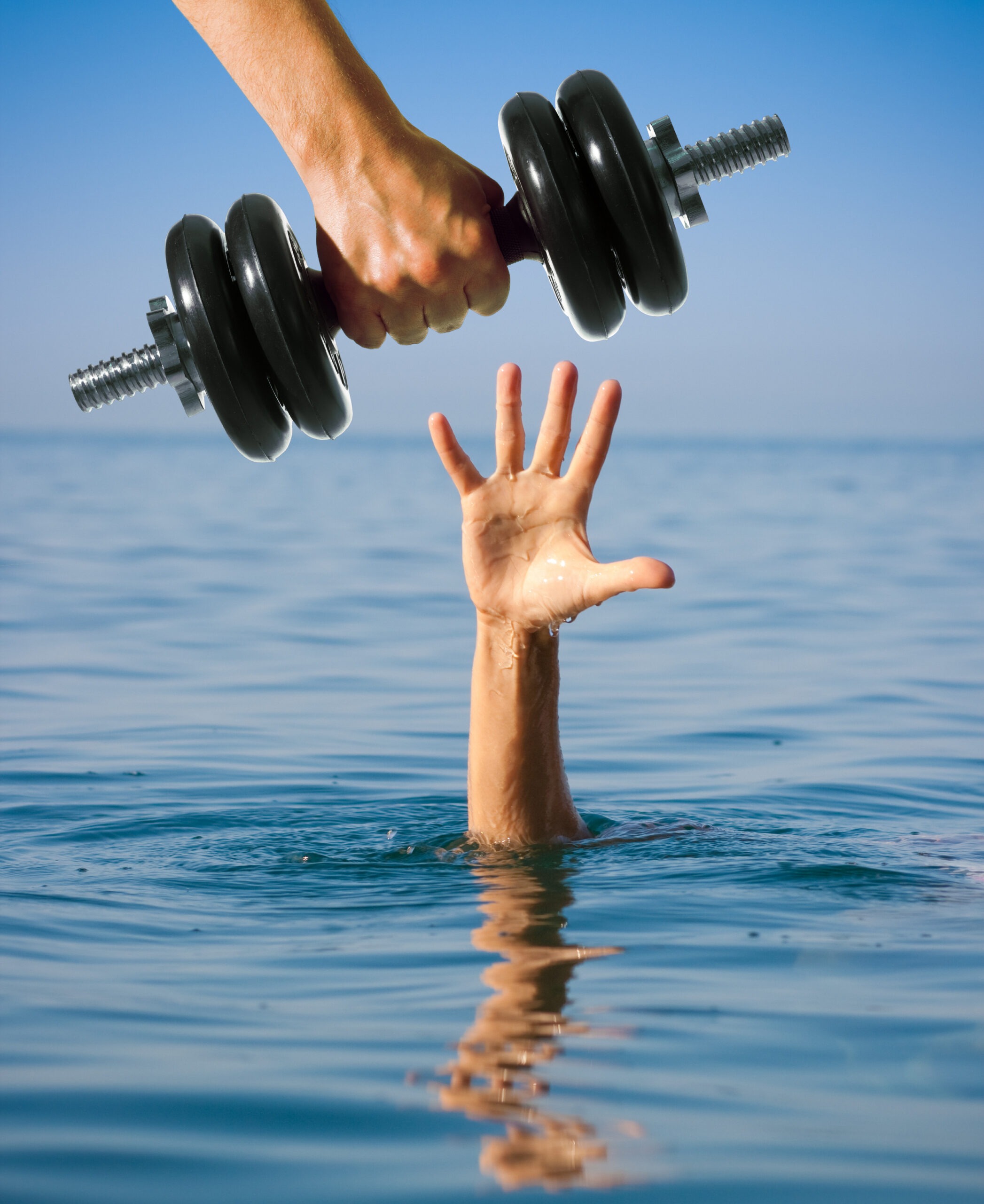 A person underwater reaches their hand out of the water for help, while an arm reaches down with a dumbbell in its hand.