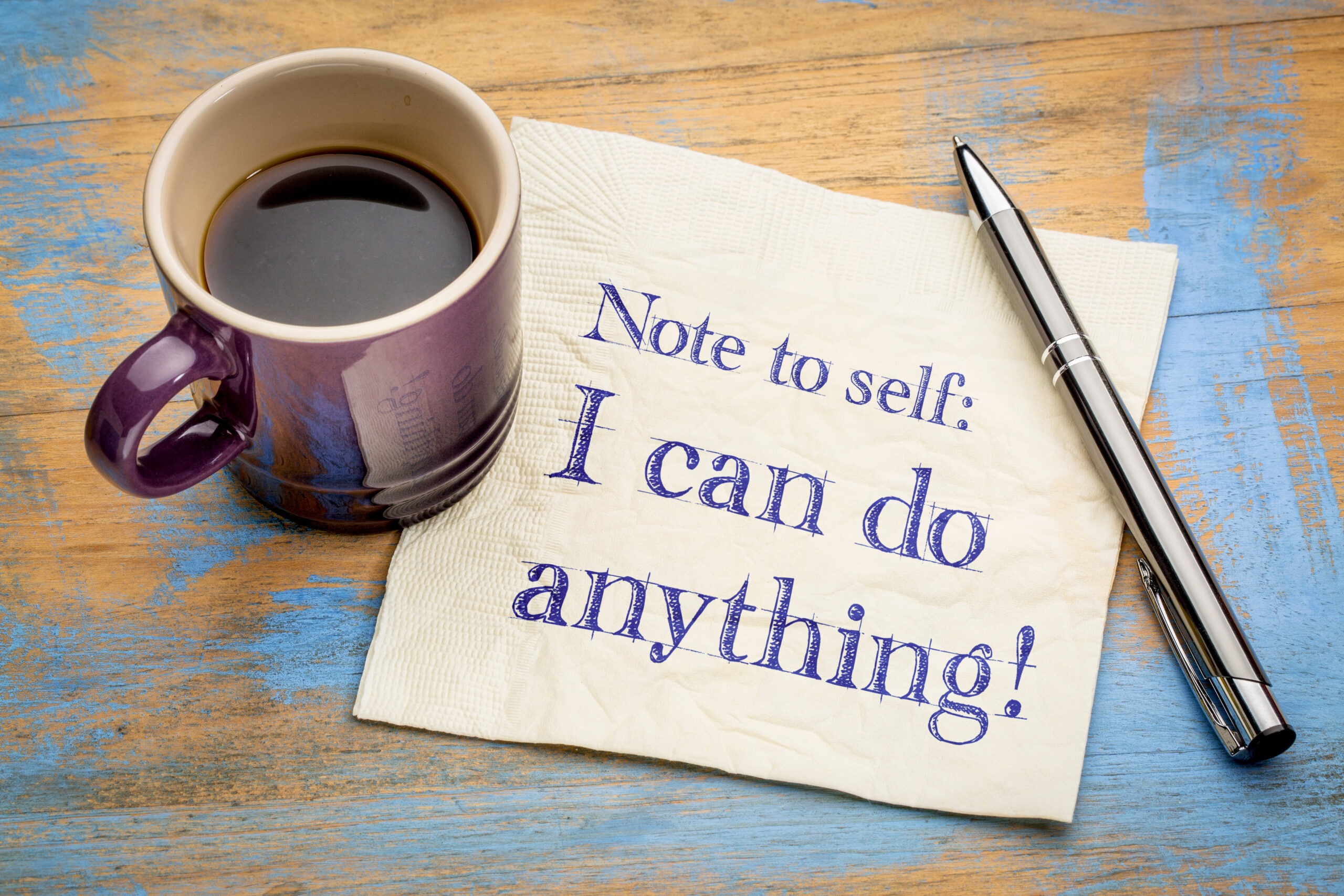 A napkin is held down by a cup of coffee and a pen. It reads "note to self: I can do anything!", serving as a reminder that you can figure out how to keep going even when it's hard.