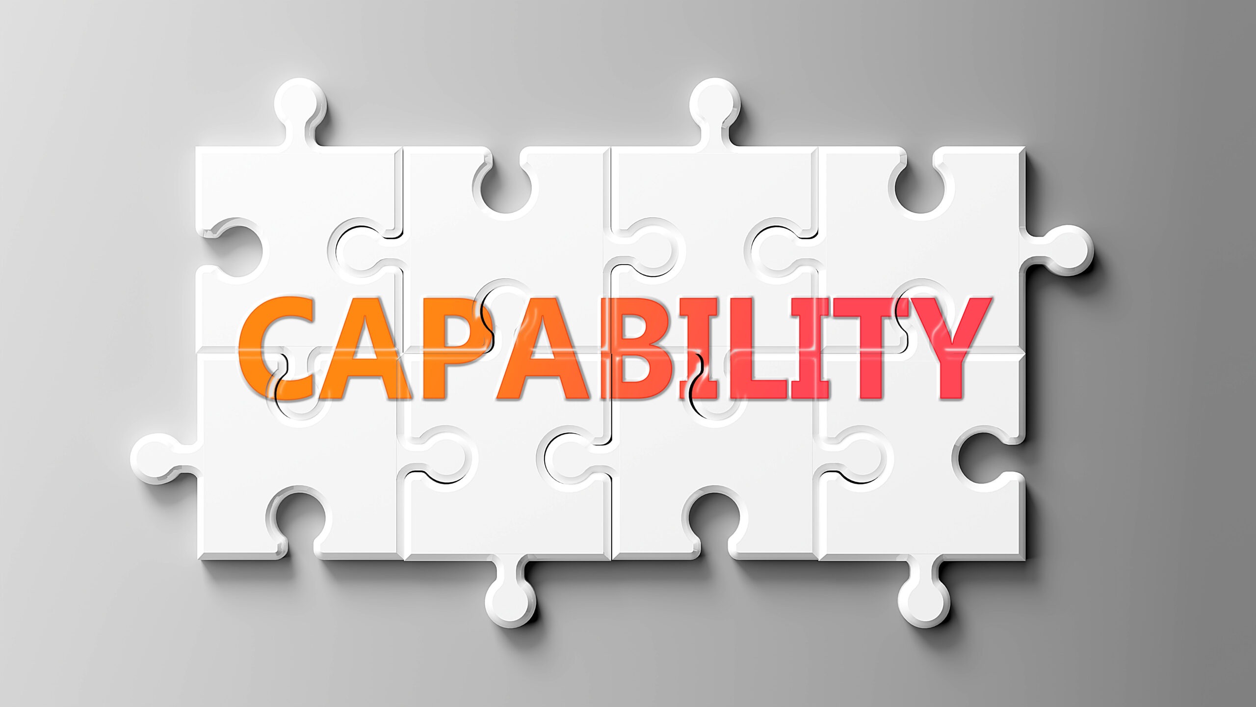 The word "capability" is written in orange and pink across several white puzzle pieces. An ICF Master Certified Coach has many capabilities and experiences that are relevant to their clients.