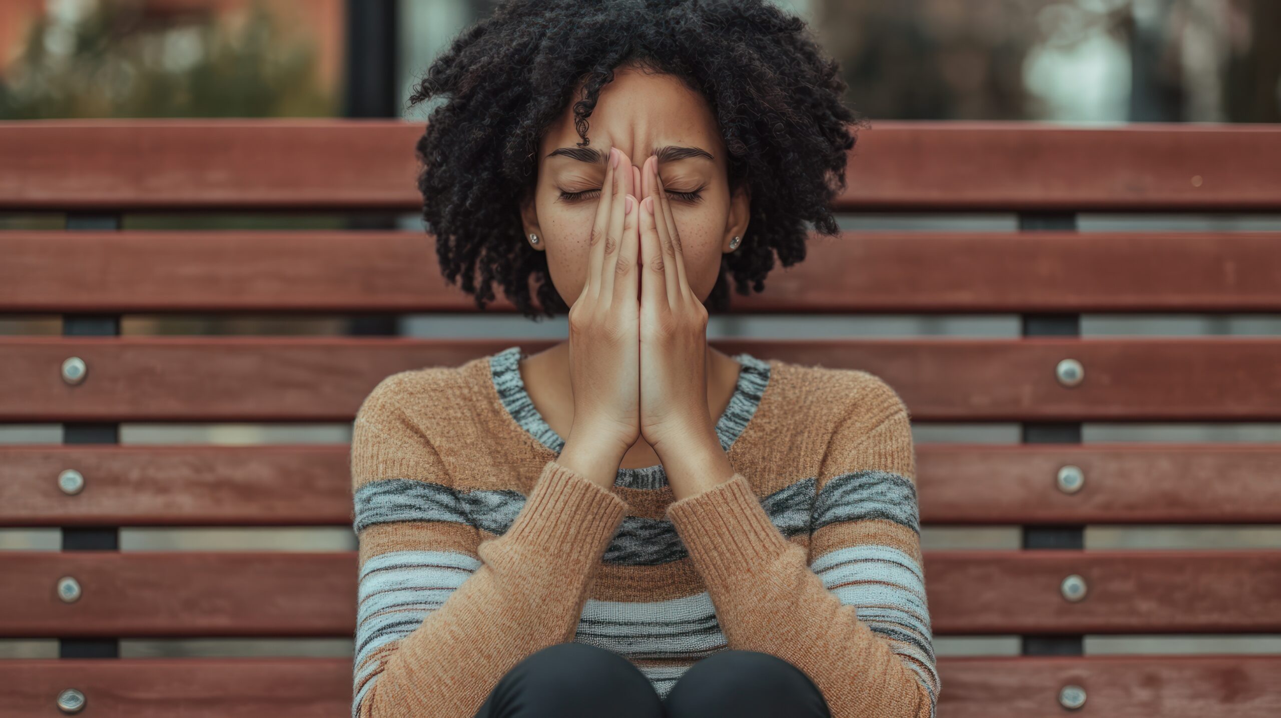 Lonely Depressed woman with hands in prayer position.