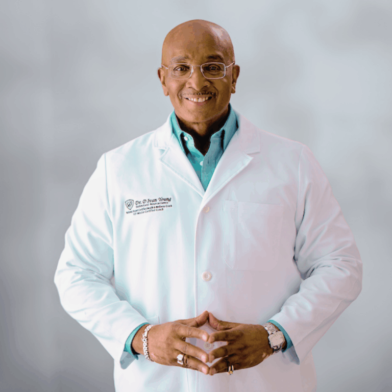 Dr. D Ivan Young, MCC, NBC-HWC in lab jacket.